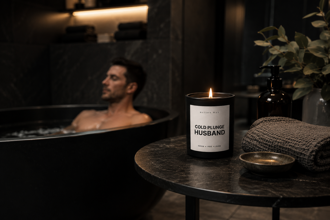A dad in a cold plunge with the Maison Wax Cold Plunge Husband candle lit nearby - a Father's Day gift for the cold-plunge dad.