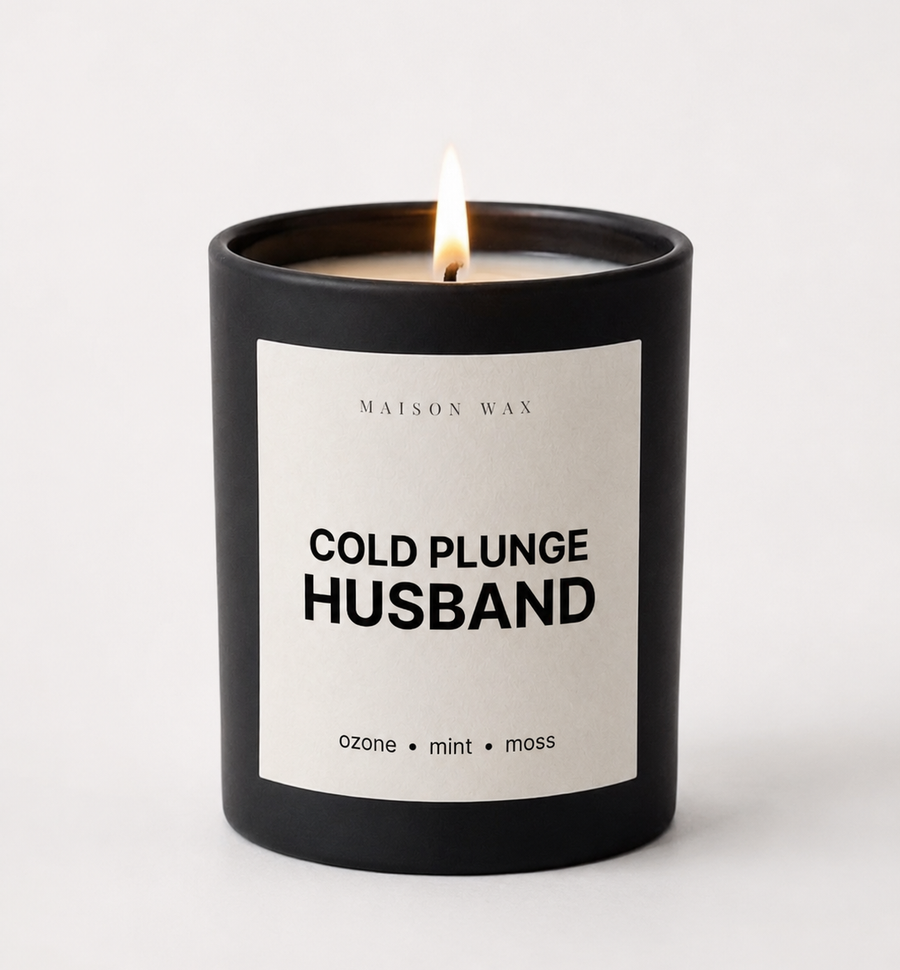 Maison Wax 'Cold Plunge Husband' candle, lit, with ozone, mint, and moss scent notes.