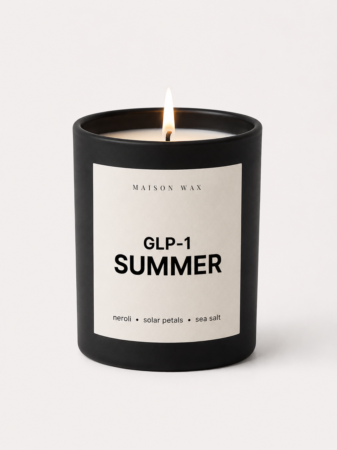 Maison Wax 'GLP-1 Summer' candle, lit, with neroli, solar petals, and sea salt scent notes.