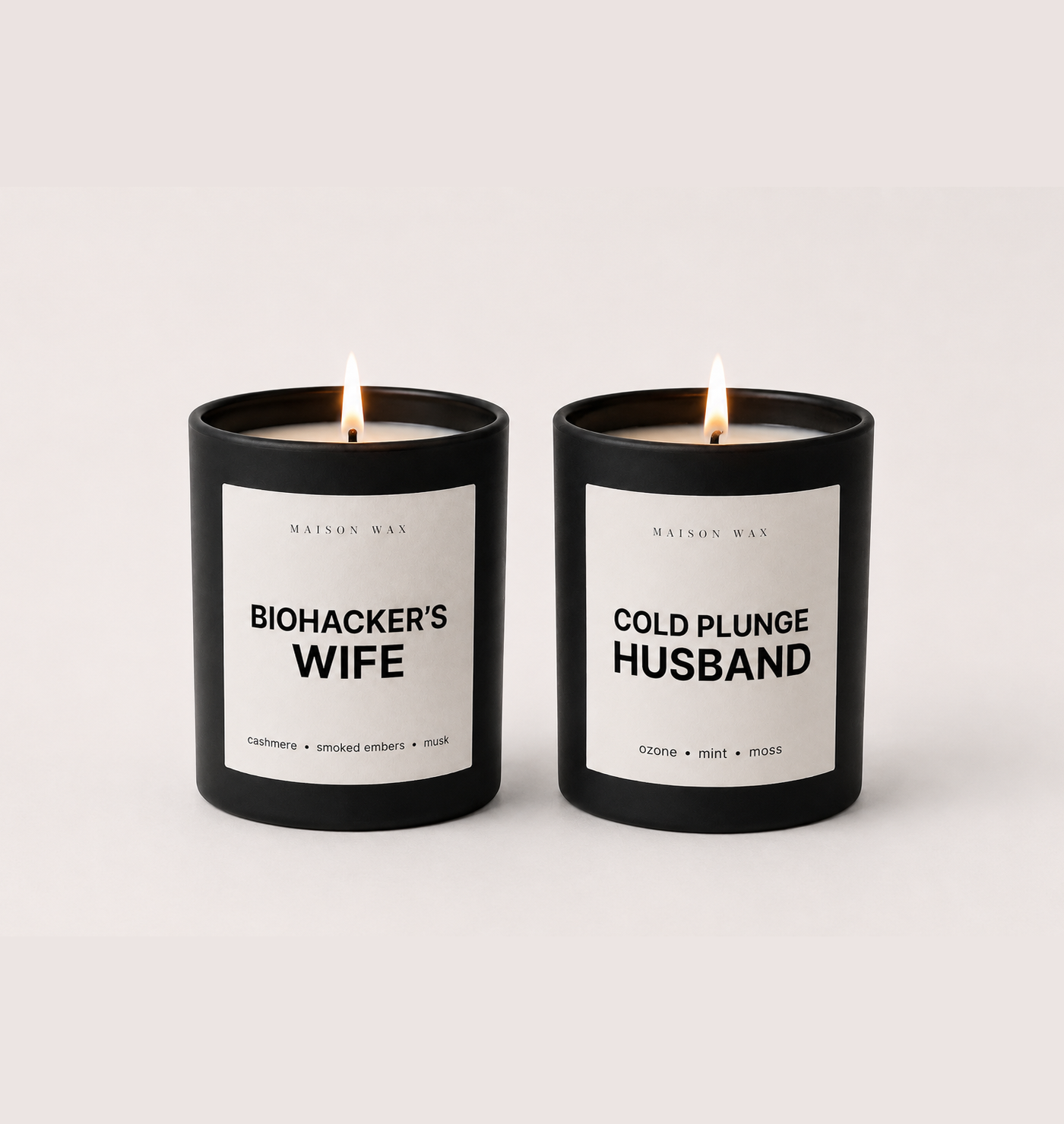 Maison Wax His & Hers candle set - Biohacker's Wife and Cold Plunge Husband candles, both lit.