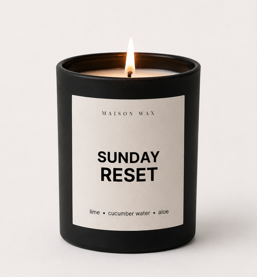 Maison Wax 'Sunday Reset' candle, lit, with lime, cucumber water, and aloe scent notes.